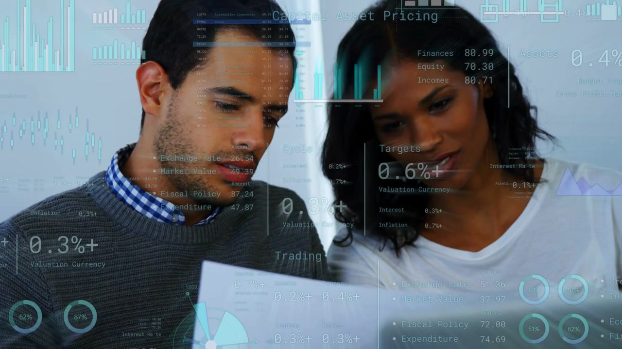 Man turning report, woman tapping laptop, reviewing finance charts with data overlays across page