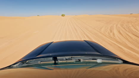 Driving-through-the-vast-Sahara-desert-in-Merzouga-on-a-sunny-day