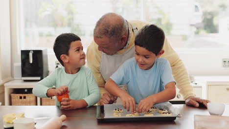 Grandfather,-talking-or-children-baking-in-kitchen