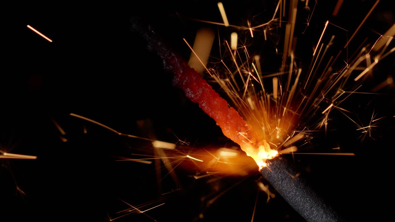 fuego de bengala luces brillantes ardiendo frente a un fondo negro, primer plano 4k, cámara lenta