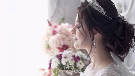 slow-motion-close-view-woman-with-tiara-stands-at-window