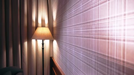 pull back shot of a decorative wall in a luxurious hotel room with night lamps in focus