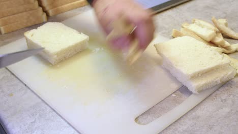 man cutting bread for cooking