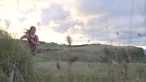 Woman-running-exercise-beautiful-location-at-sunrise-low-angle-camera-shot