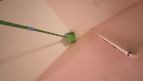 pov shot of a cleaner brush cleaning roof of an indian household