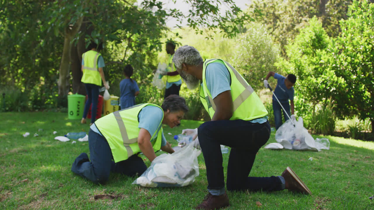 Happy family cleaning a garden together