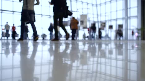 people walk inside a bright, modern building