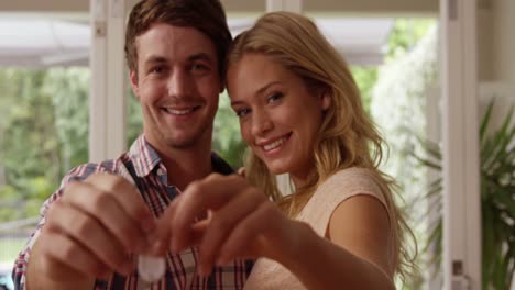 happy couple holding keys together