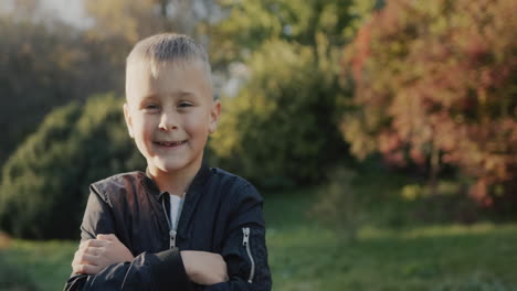 portrait of a cheerful boy in the autumn park.