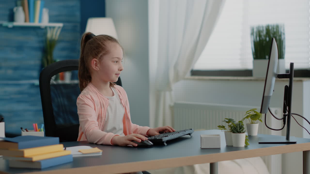 Pupil using keyboard and computer for online class lessons