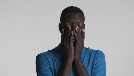 Tired-African-american-man-on-grey-background.