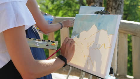 women painting outdoors