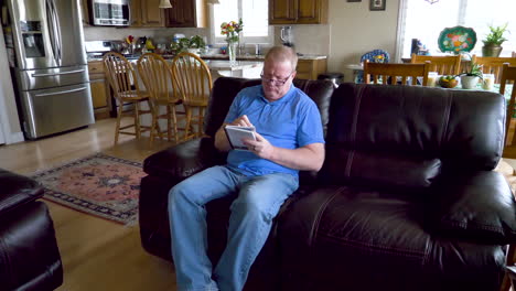 a lonely senior man in a dark home setting writes a note, in a journal or in a diary