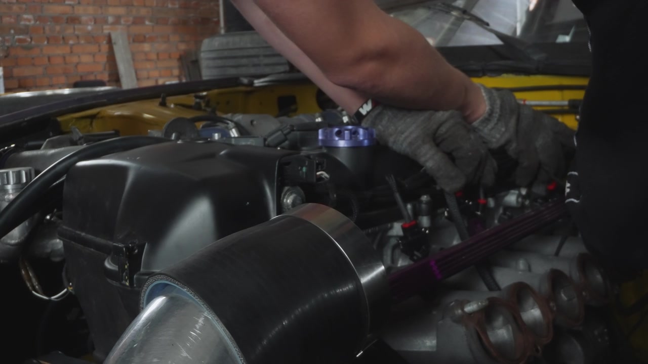 Professional Mechanic Working on a Car Engine in a Garage