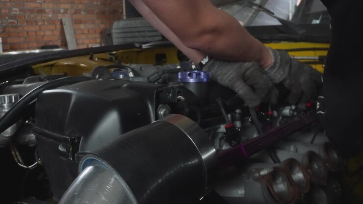 Professional Mechanic Working on a Car Engine in a Garage