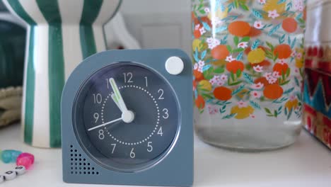 stylish alarm clock on a shelf with decor