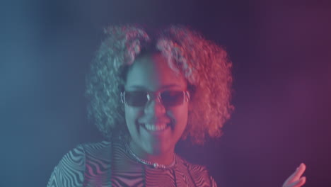 stylish young woman in neon lighting