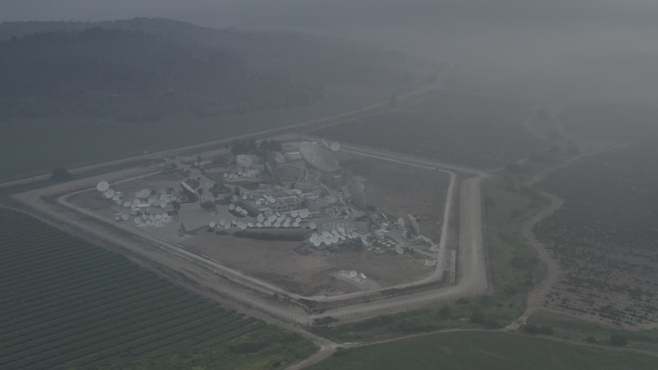 Satellite Dish Facility in Foggy Rural Landscape