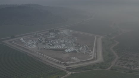 satellite dish facility in foggy rural landscape