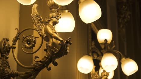 golden decorative interior wall light with angel and flowers