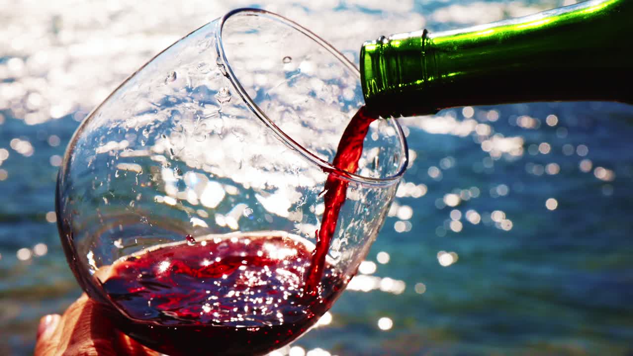 Pouring Red Wine at the Beach