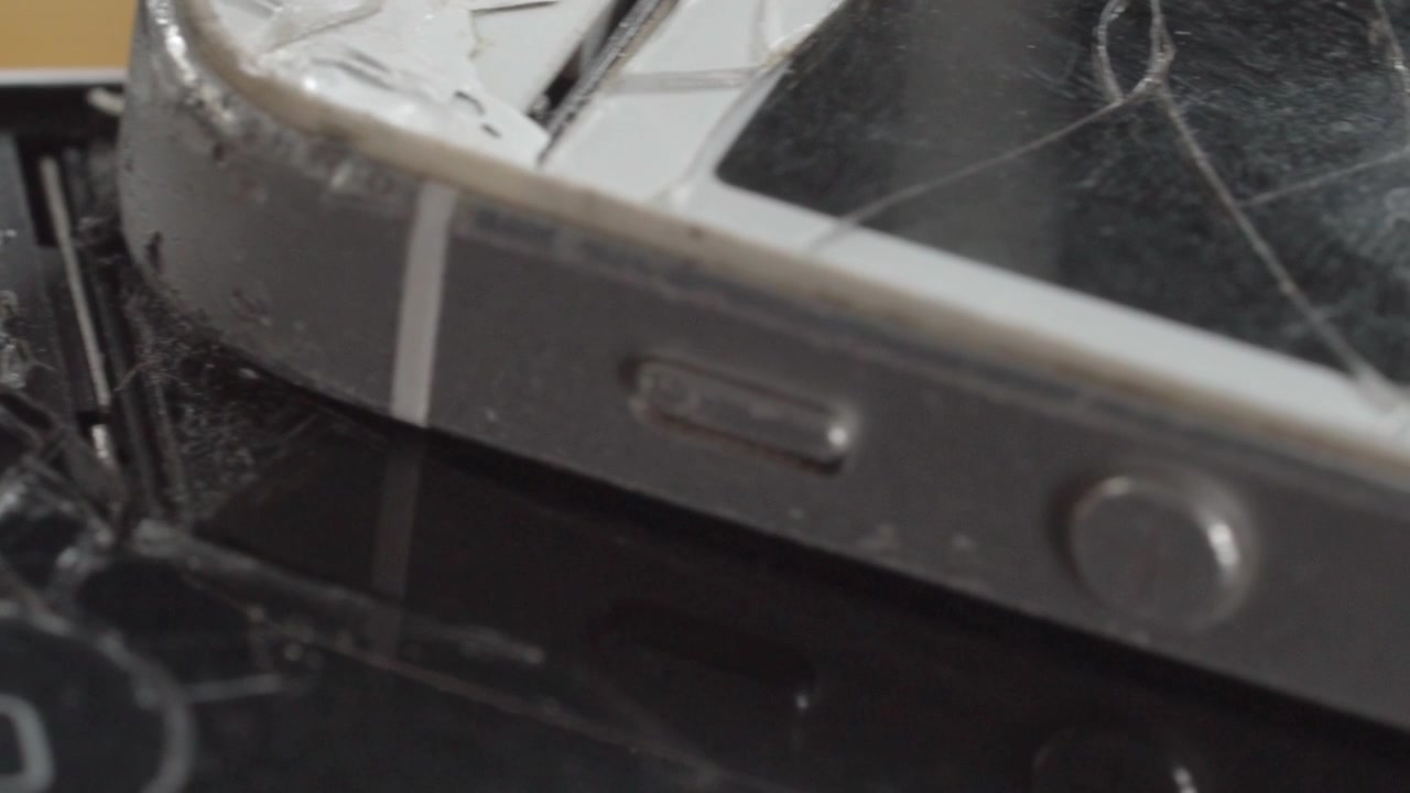 Closeup of cracked smartphone screen with shattered glass and visible impact damage. Broken mobile device highlighting repair, accident, technology failure, and maintenance