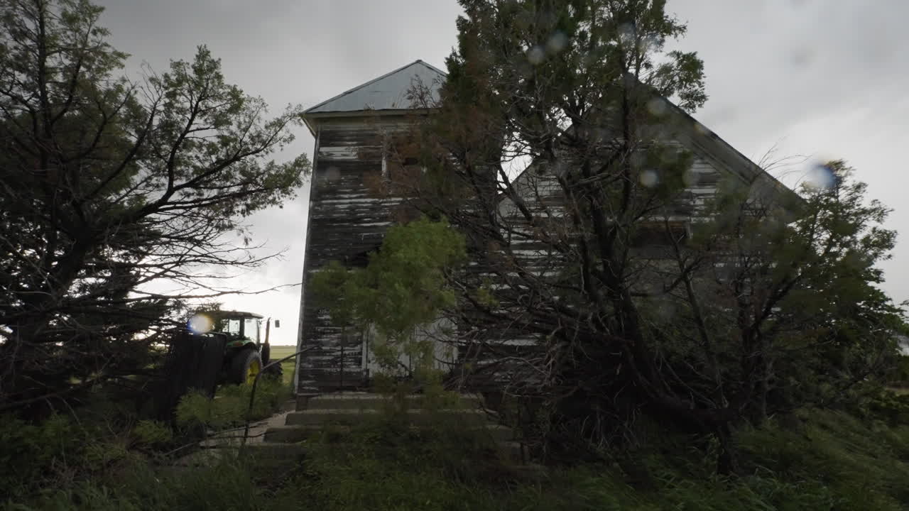 Abandoned Farm House In Stormy Weather Rain And Trees Swaying