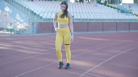 woman jogging on outdoor track in sportswear at athletic field