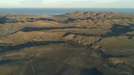 aerial view of a mountainous coastal landscape with vineyards