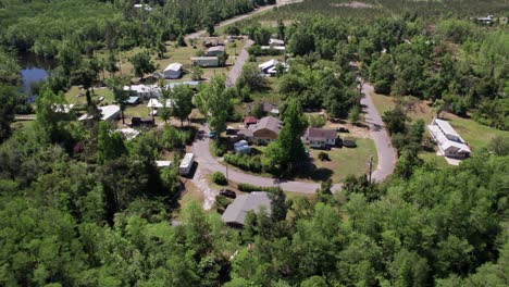 Aerial-residential-flight-over-middle-class-neighborhood-tucked-away-in-a-dense-forest-far-away-from-society