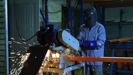 metalsmith using cutter machine in workshop 4k