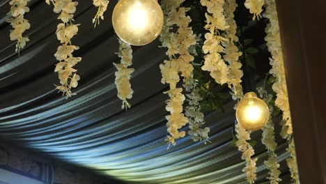 hanging flower decorations with large round light bulbs from ceiling