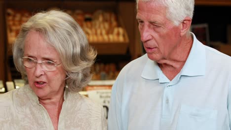 senior couple shopping in grocery store