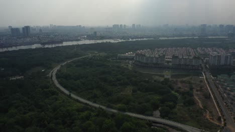 aerial-fly-in-to-a-new-upmarket-housing-development-on-the-Saigon-River-in-Ho-Chi-Minh-City,-Vietnam