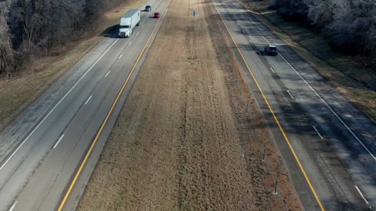 Static drone aerial view panning up to rural interstate highway road, 4K