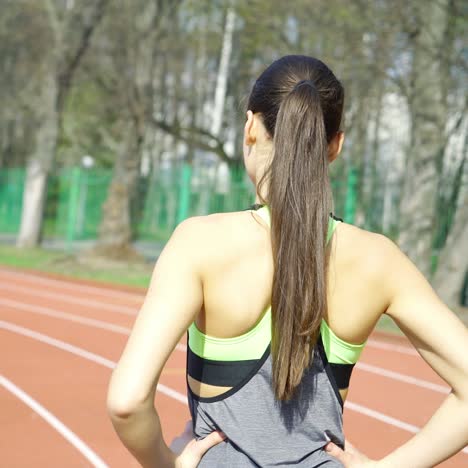female athlete getting ready to blast off outdoors at the stadium