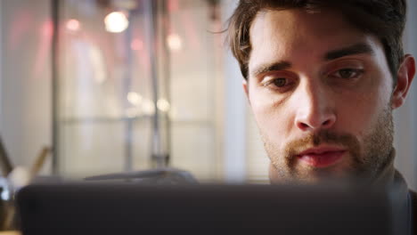 Male-Jeweller-Looking-At-Design-On-Digital-Tablet-In-Studio