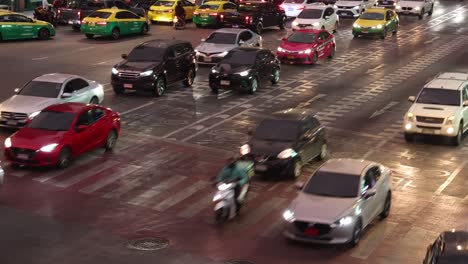 vehicles and pedestrians navigating a crowded crossroad.