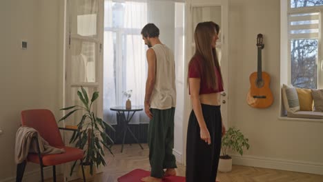 couple practicing yoga at home