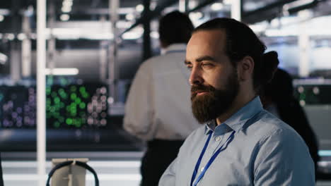 vertical video smiling data center technician using pc to monitor neural networks