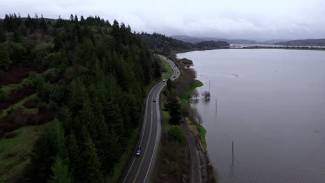 Aerial-static-shot-of-cars-drive-on-Highway-next-to-flooded-pastures-from-rain