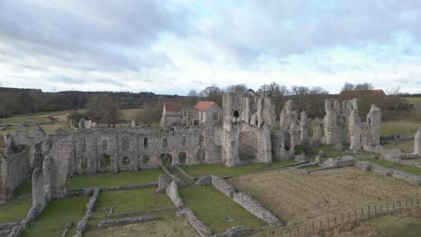 castle acre priory ruins in norfolk, clouds adorn the sky, aerial view