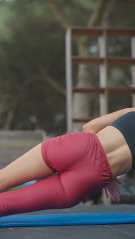 woman performing core exercise outdoors