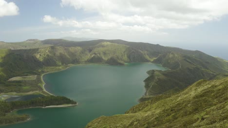 Rising-aerial-shot-of-Lagoa-do-Fogo-on-a-sunny-day