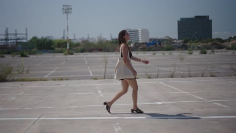 woman walking in empty parking lot