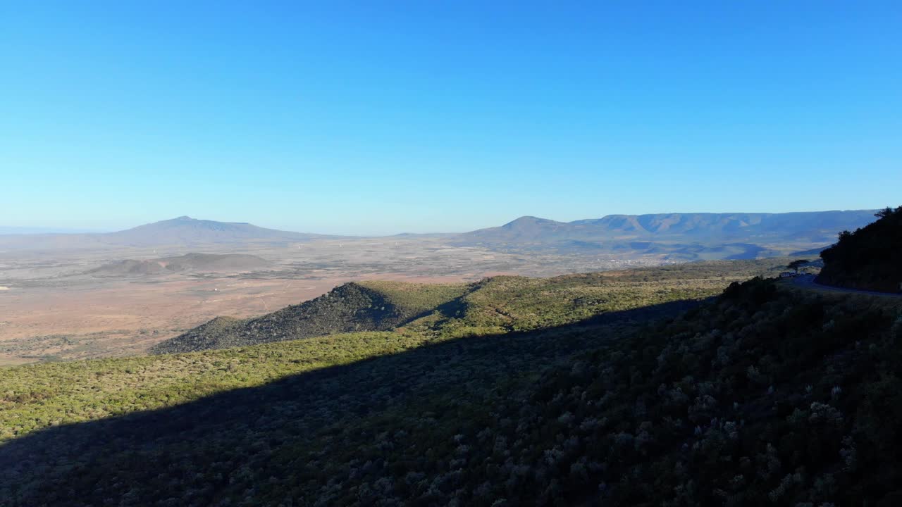 Trucks driving on edge of Kenya's Great Plateau 4K shot