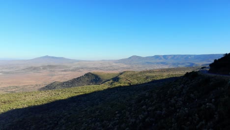 trucks driving on edge of kenya's great plateau 4k shot