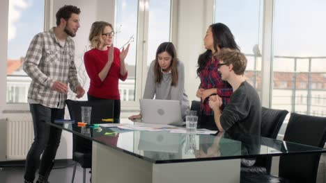 happy workers giving praise by clapping hands together for coworker