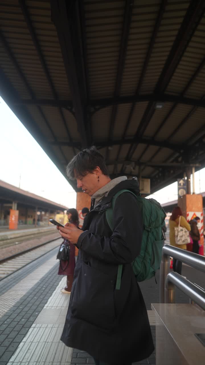 Man using phone at train station