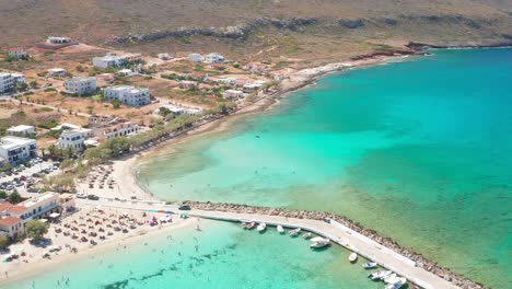 Majestic-breakwater-with-ships-anchored-in-turquoise-water,-Diakofti-Beach